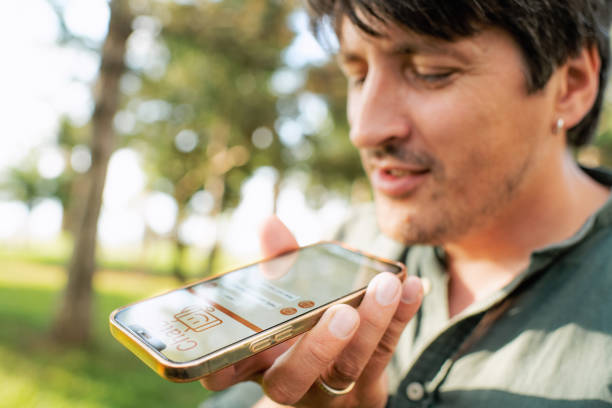 Mature man talking to a chatbot using smartphone